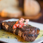 Prime New York Strip with Truffle Buttered King Crab