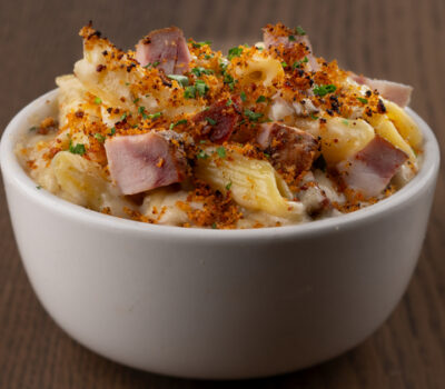 Rich, creamy Mac & Cheese embellished with savory bites of Perry’s Famous Pork Chop. With a blend of cheeses, this Mac & Cheese is brought together into a warming bite with hints of nutmeg, then baked to melty, bubbly, and golden-brown perfection.